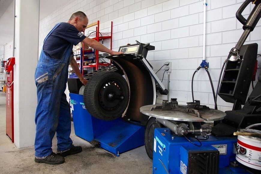 Monteur gebruikt bandenmontagemachine tijdens wielservice